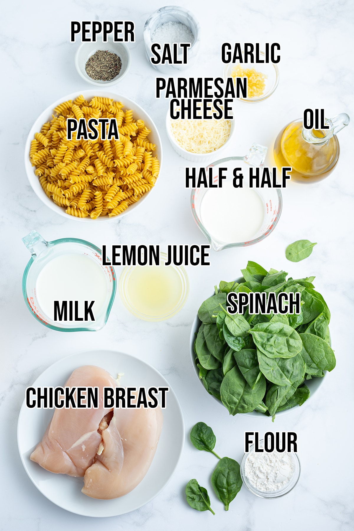 An overhead photo of the ingredients needed to make creamy lemon chicken pasta with spinach.