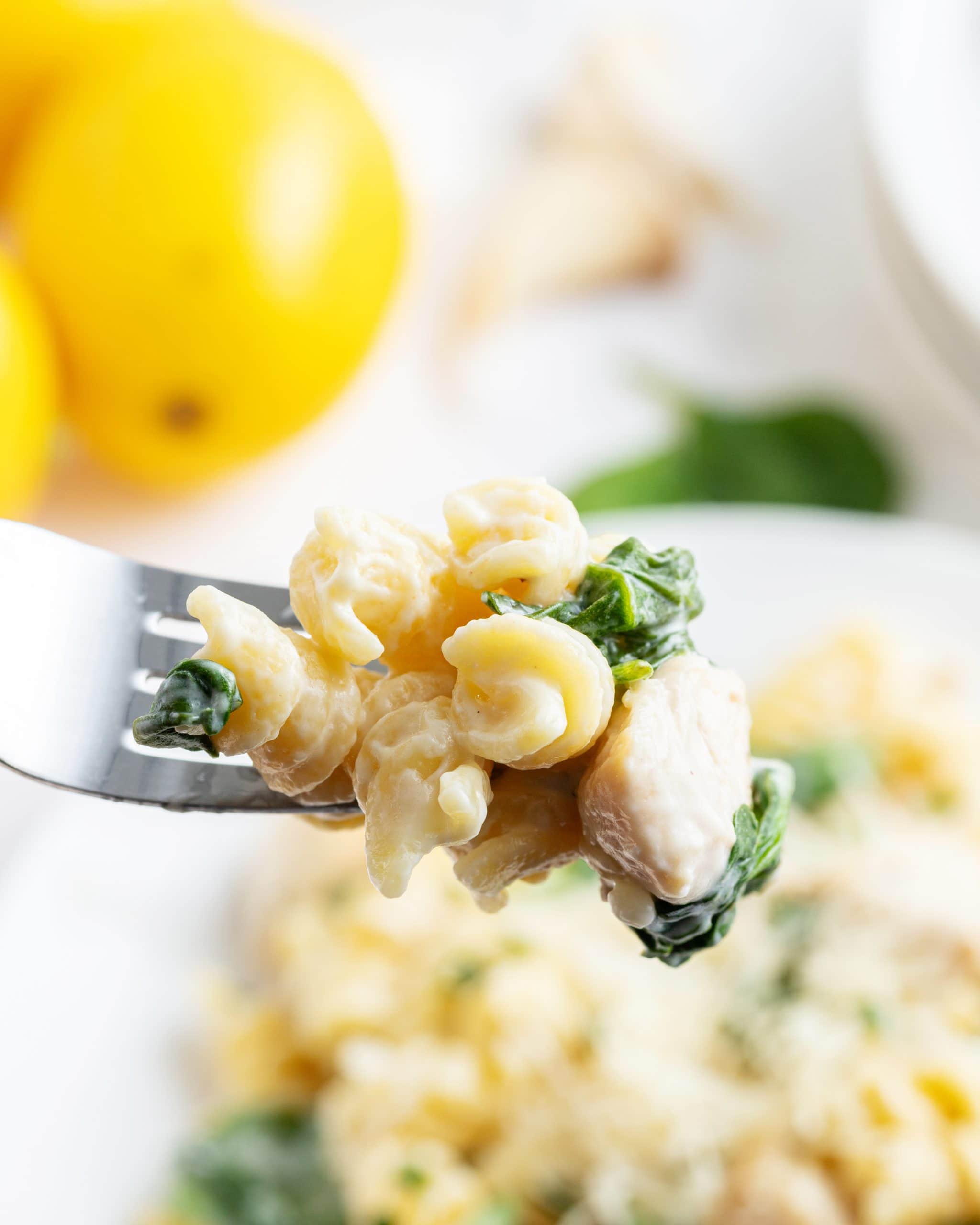A bite-full of lemon chicken pasta on a fork.