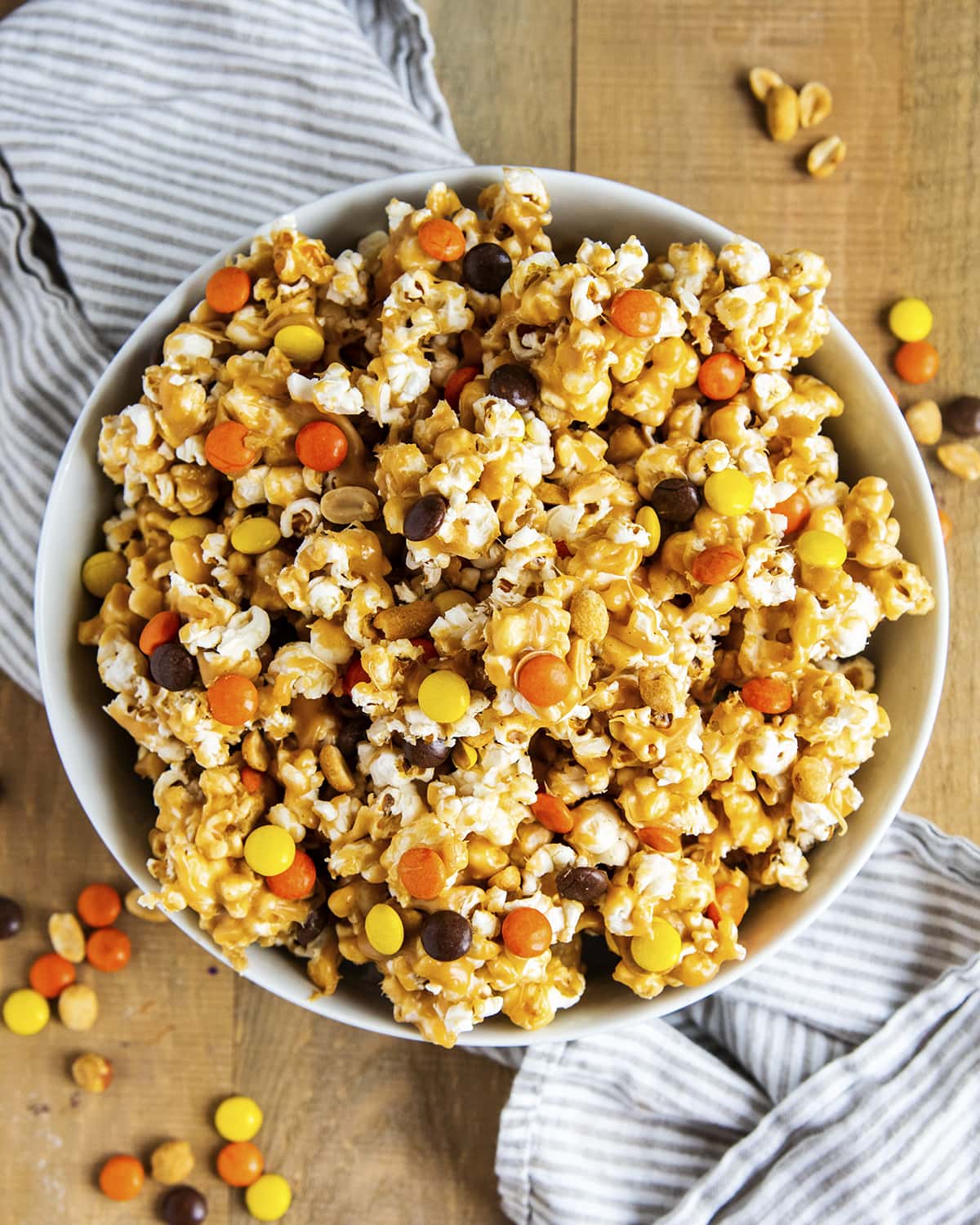An overhead photo of peanut butter popcorn in a large white bowl.