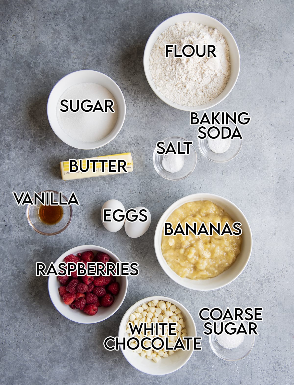 An overhead photo of the ingredients needed to make raspberry and white chocolate chip banana bread.