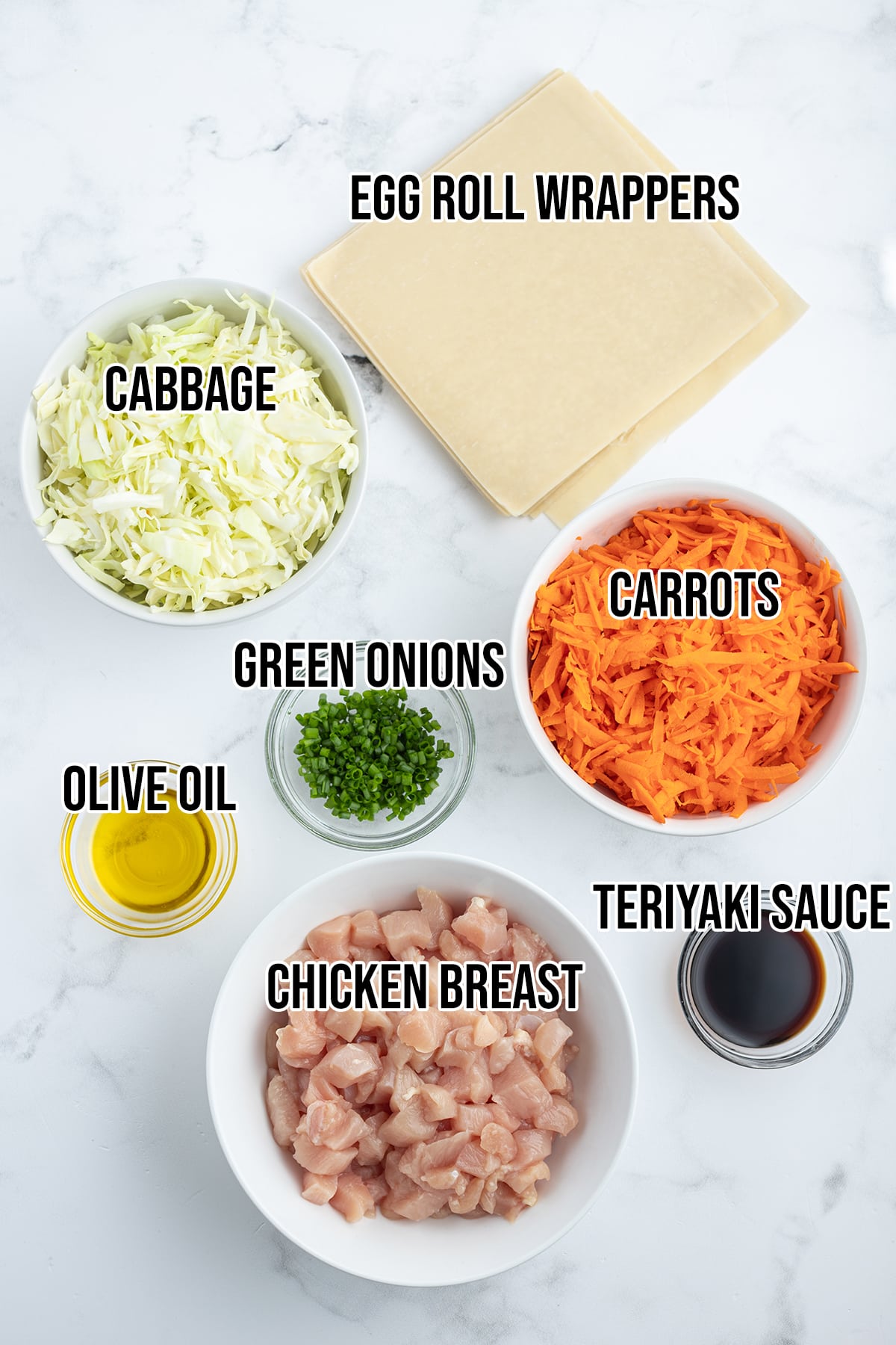 An overhead photo of the ingredients needed to make chicken egg rolls at home.