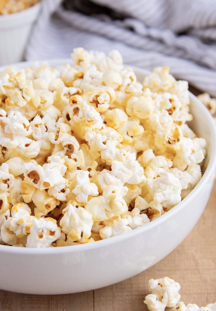 A side view of a bowl of homemade kettle corn.