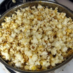 Angled view of kettle corn in a metal bowl.