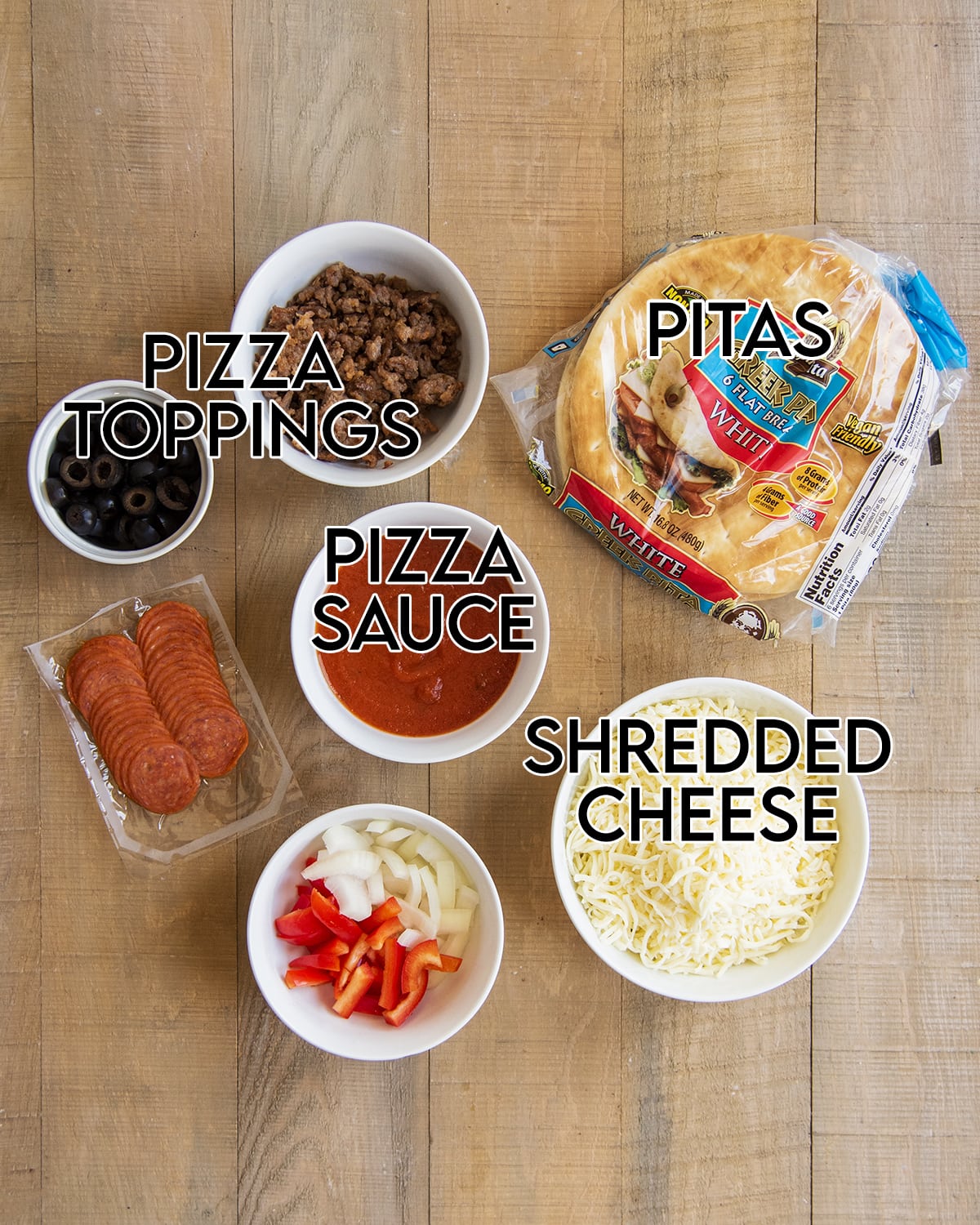 An overhead photo of the ingredients needed to make pita pizzas. 