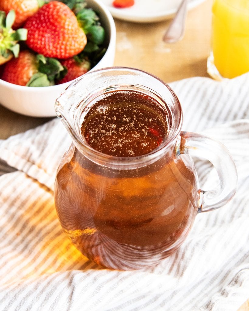 A pitcher of homemade maple syrup.