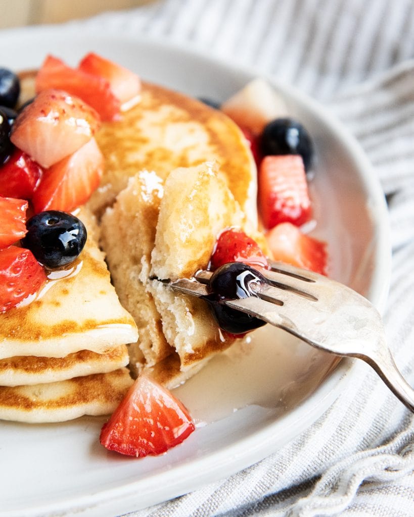 A bite of pancakes on a fork.