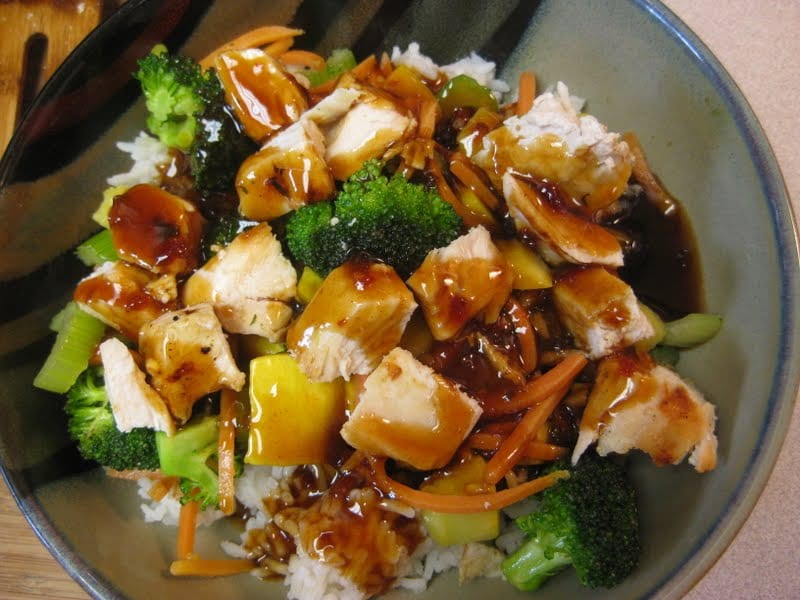 Top view of chicken teriyaki with vegetables on rice.