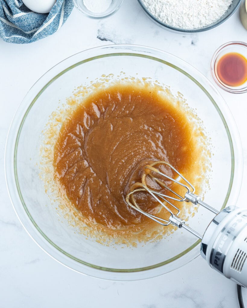 A mixing bowl full of melted butter mixed with sugar.