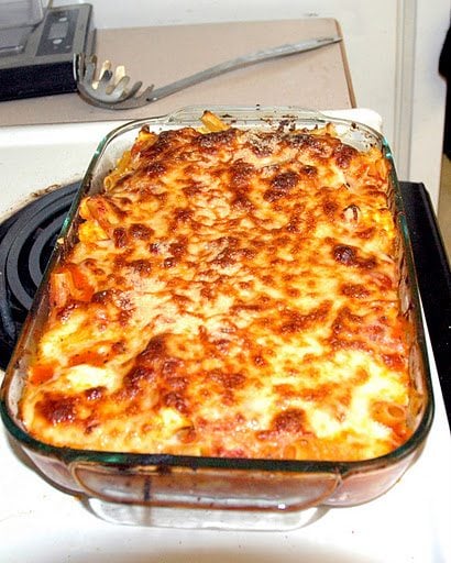 Front view of baked lasagna in a glass bake pan.