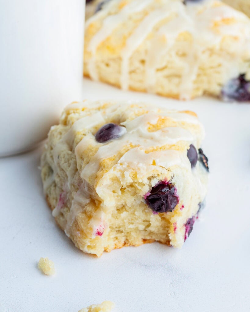 A blueberry scone with a bite out of the front.