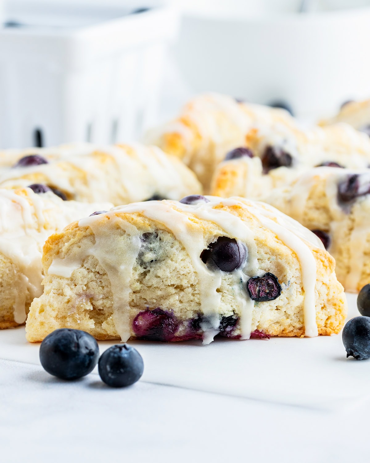 A blueberry scone with vanilla icing on top.
