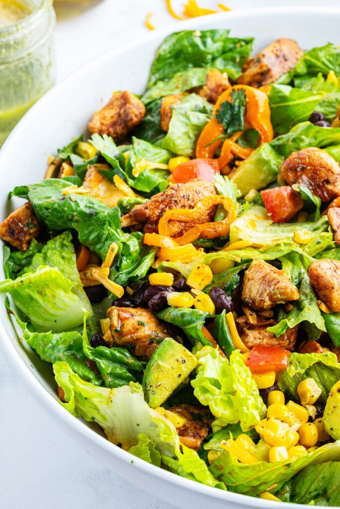 A close up photo of a bowl of chicken taco salad.
