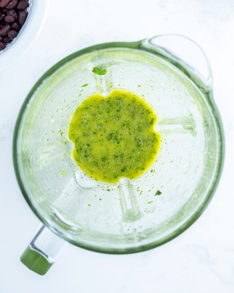 A blender of cilantro salad dressing.