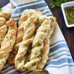 A pile of twisted garlic bread sticks that look almost like braids