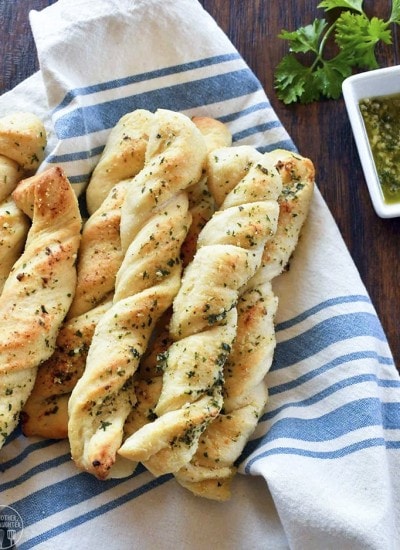A pile of twisted garlic bread sticks that look almost like braids