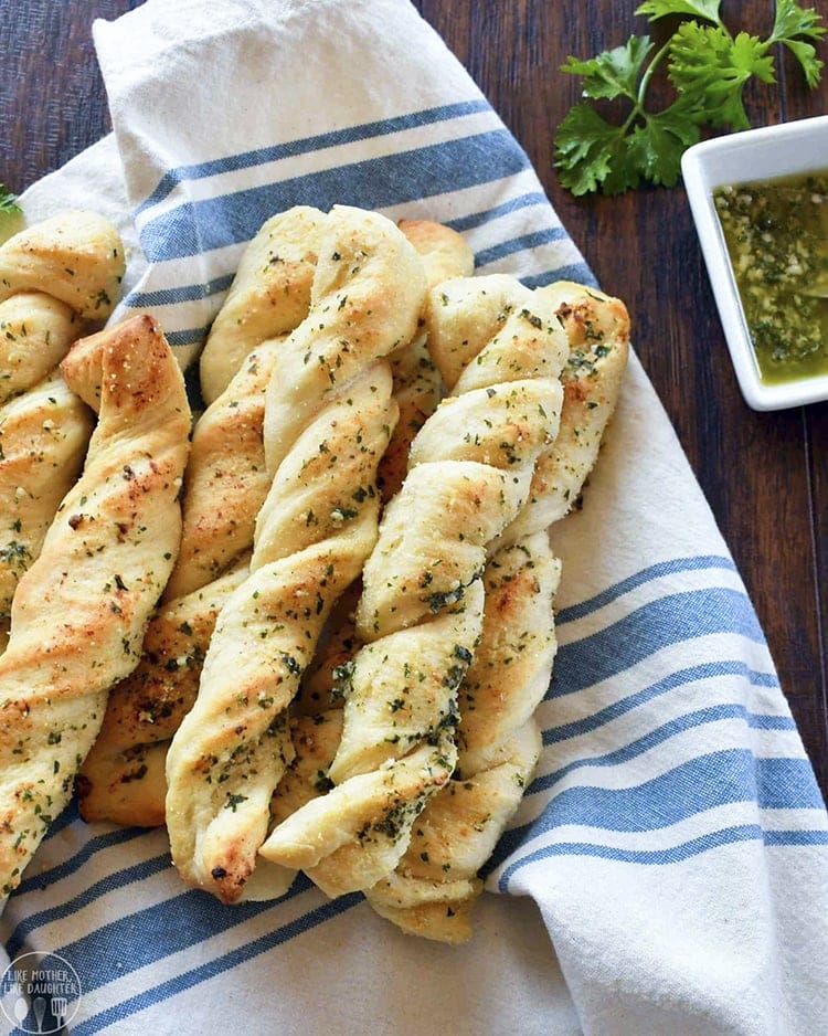 A pile of twisted garlic bread sticks that look almost like braids