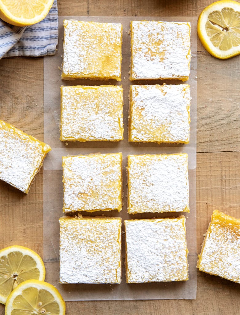 Rows of lemon bar squares with powdered sugar on top of them.