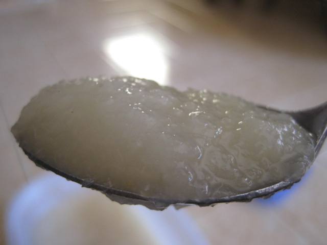 Close up view of pearsauce in a on a spoon.