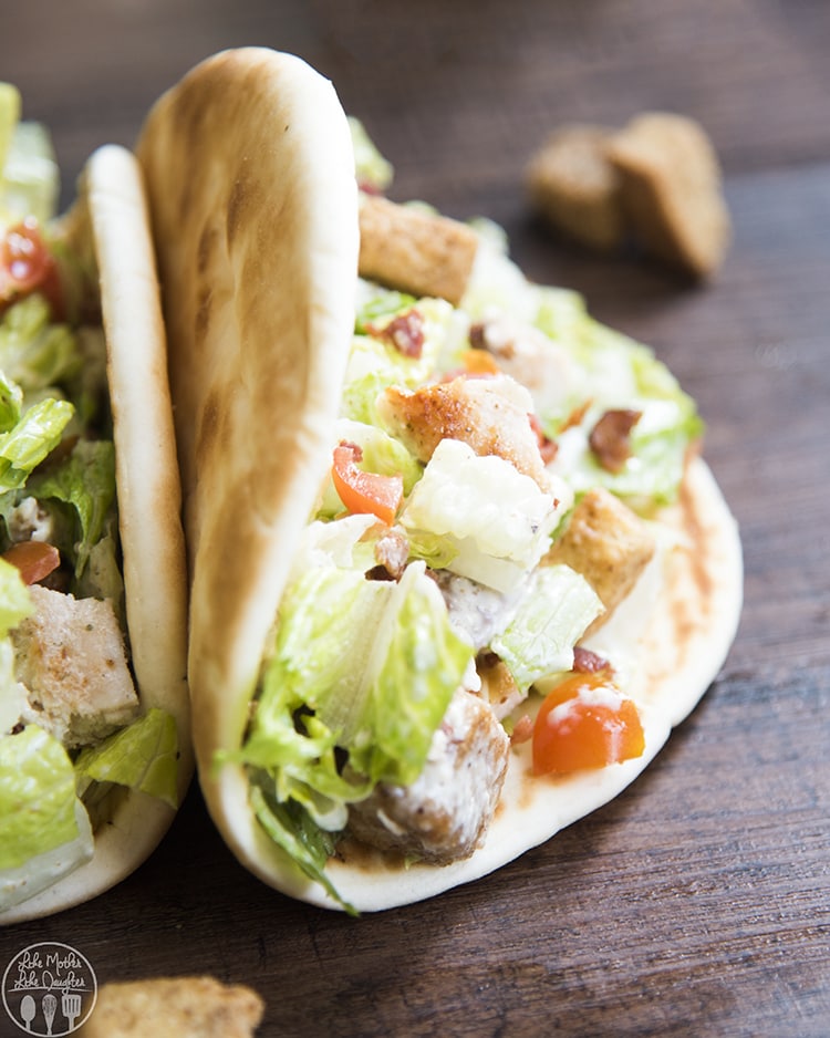 A close up of a pit full of chicken caesar salad.