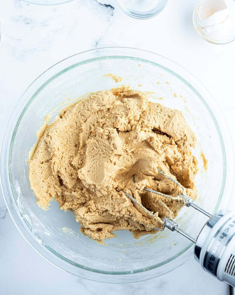 A peanut butter cookie dough in a b owl.