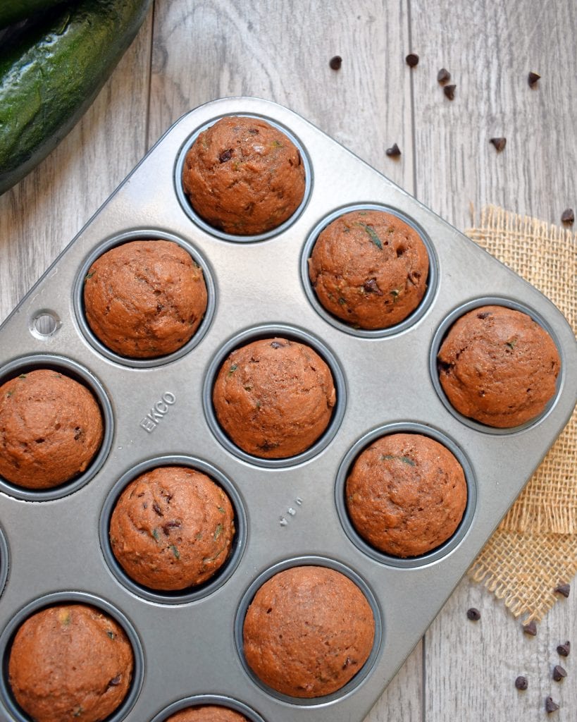 Top view of chocolate zucchini muffins in a muffin pan.