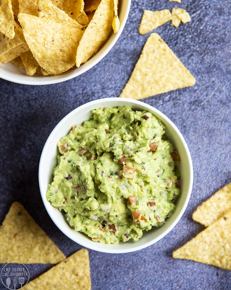 Guacamole in a bowl with chips around it