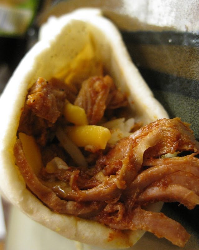Close up view of mexican pulled pork in a tortilla.
