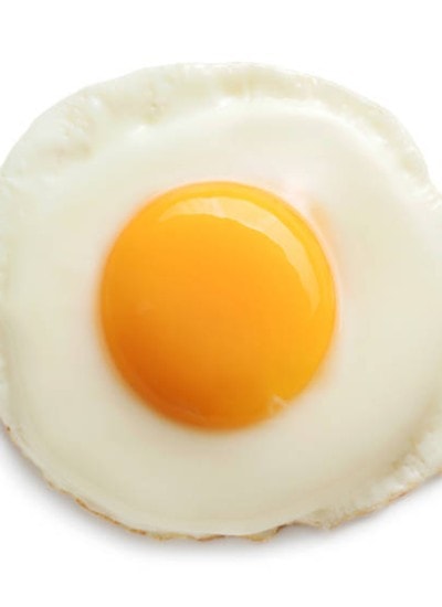 A sunny side up egg on a white background.