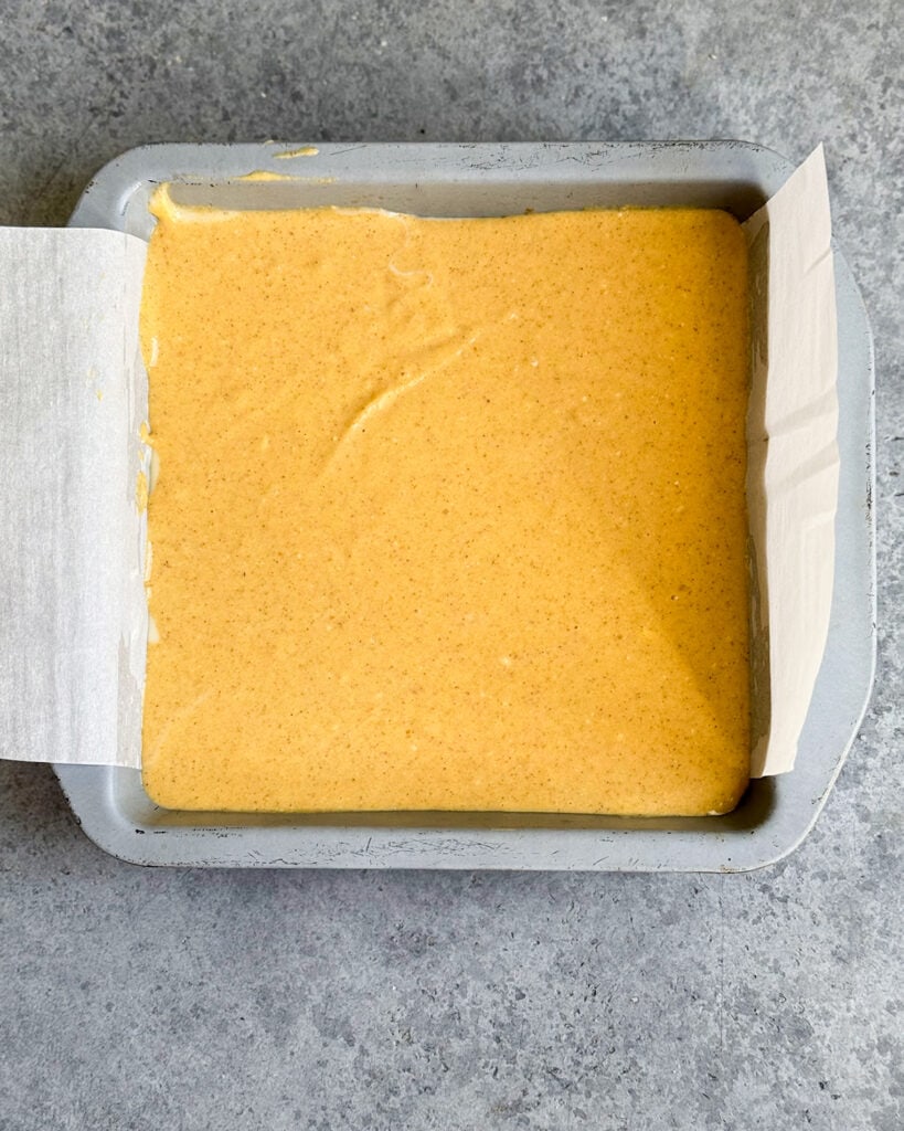 A pan of uncooked pumpkin cheesecake.