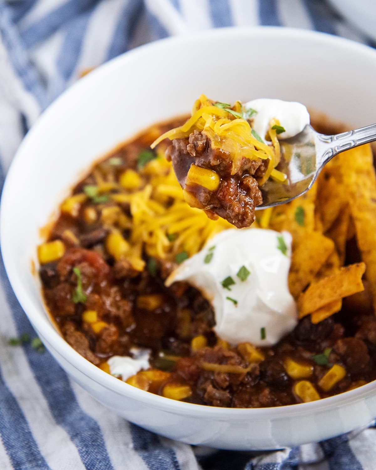 A bowl of taco soup with a spoonful of soup being held above it.