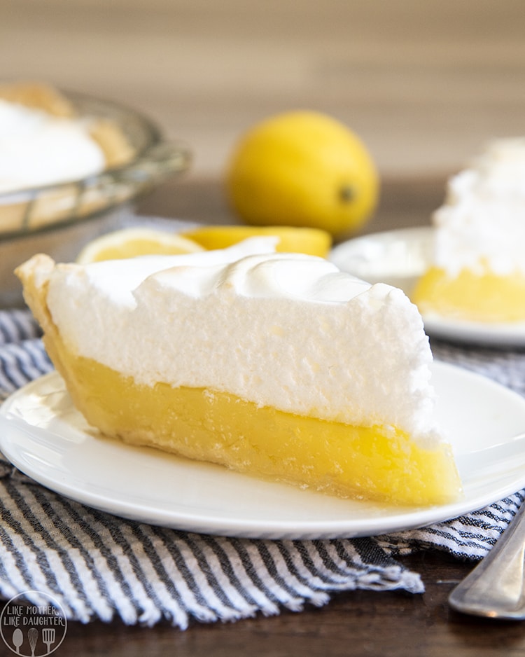 A slice of lemon meringue pie on a white plate.
