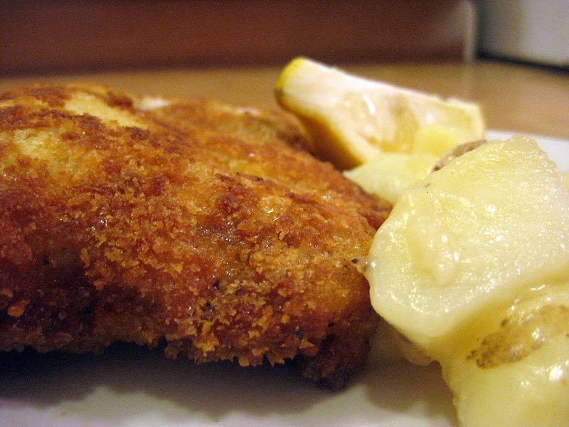 Side view of wiener schnitzel on a white plate.