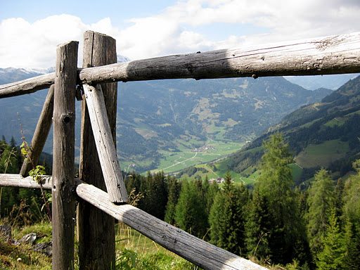 View of a mountain with wood fence in foreground.