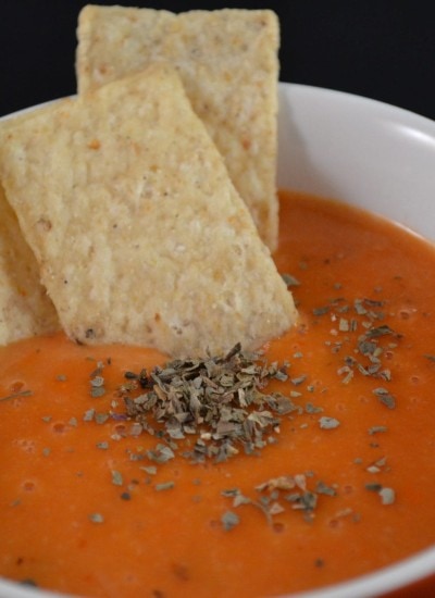 Close up view of creamy parmesan tomato basil coup in a bowl.