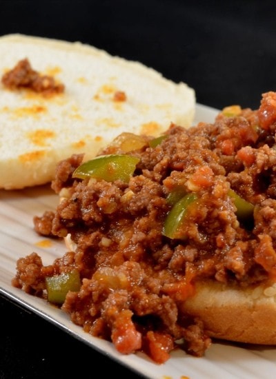 Angled view of sloppy joes on a white plate.