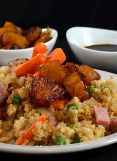 Close up view of pineapple fried rice on a plate.