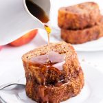 Apple Butter French Toast slices on a plate with syrup being poured over the top.