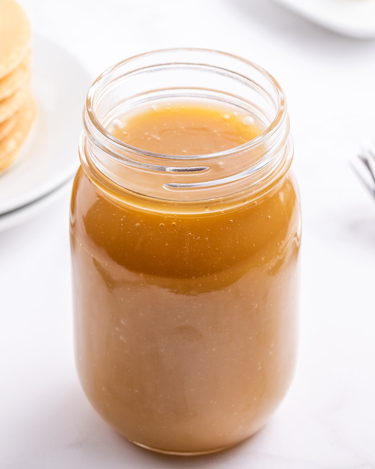 A jar of buttermilk syrup without a lid on it.