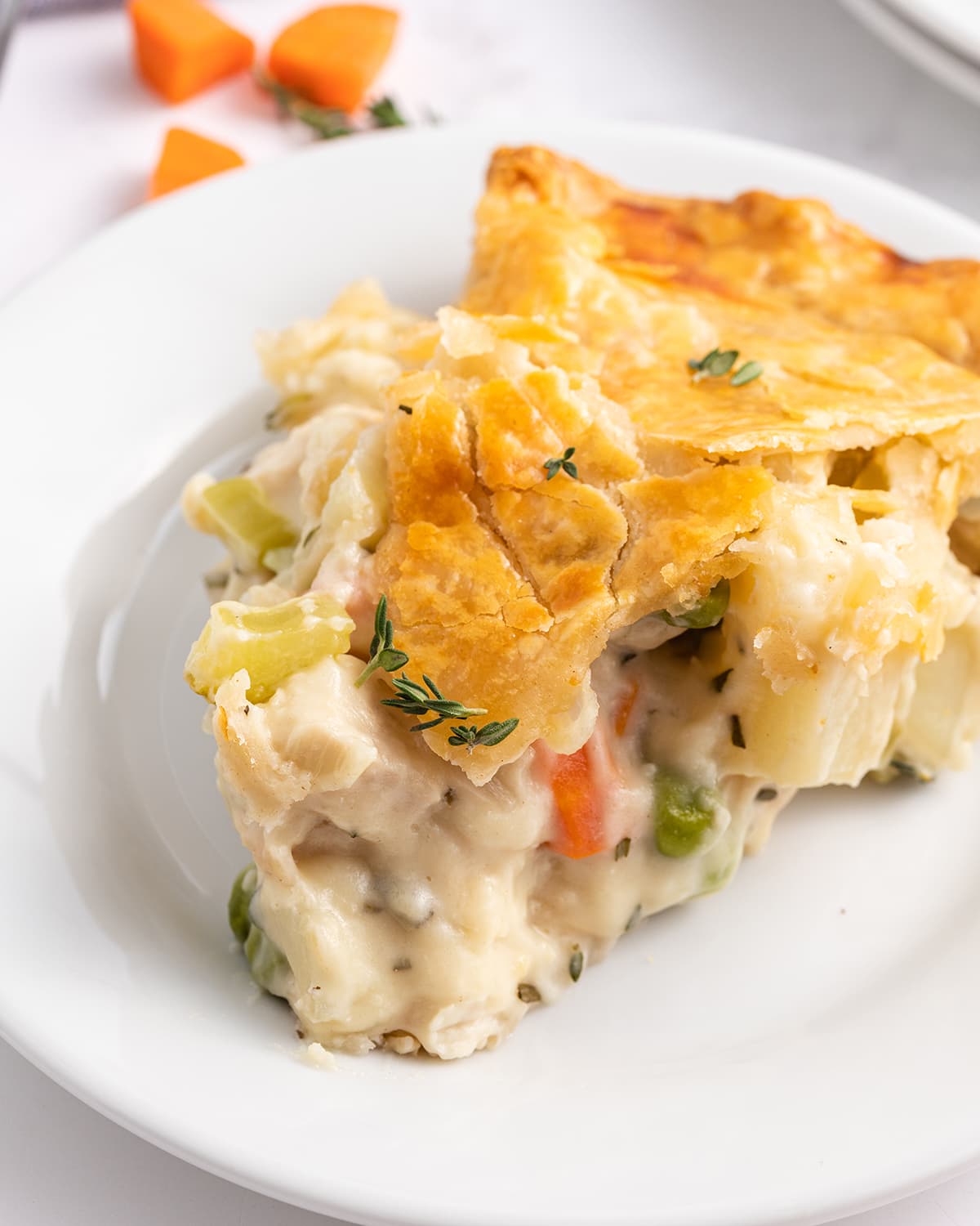 A close up photo of a slice of chicken pot pie.
