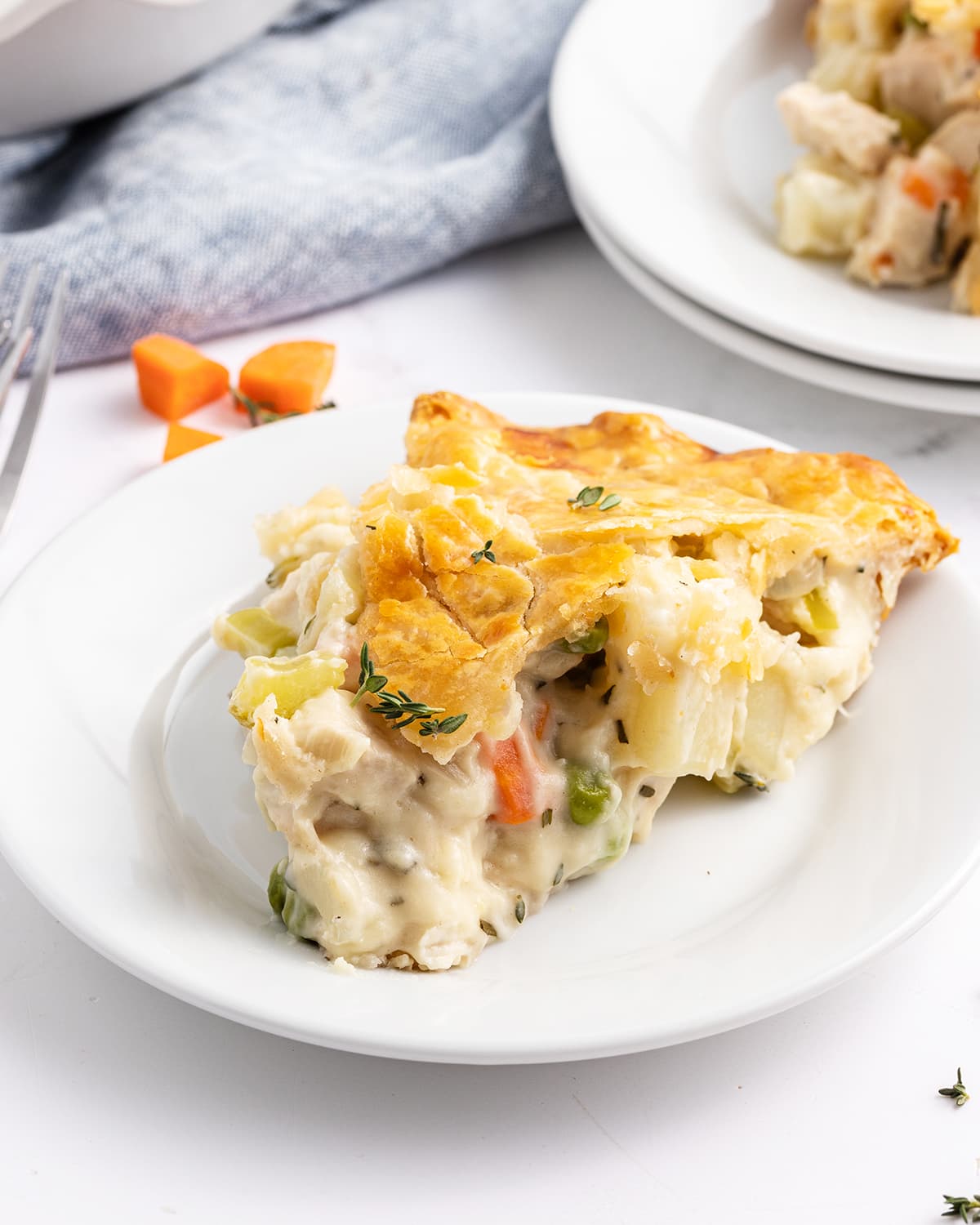 A slice of chicken pot pie on a plate.