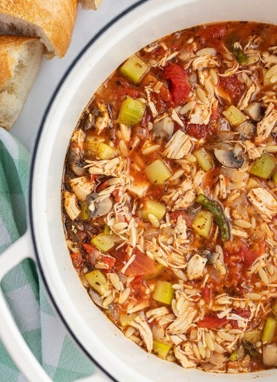 A pot of Italian Turkey Orzo Soup loaded with lots of vegetables.