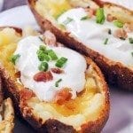 Close up view of loaded potato skins on a plate.