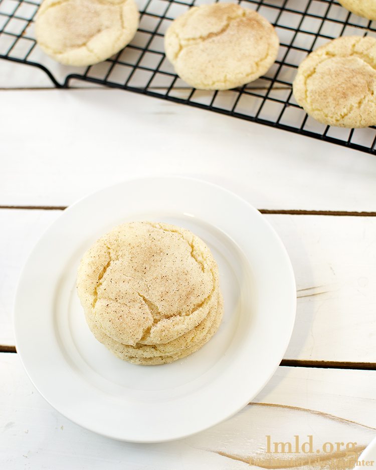 Top view of a snickerdoodle cookie on a white plate.