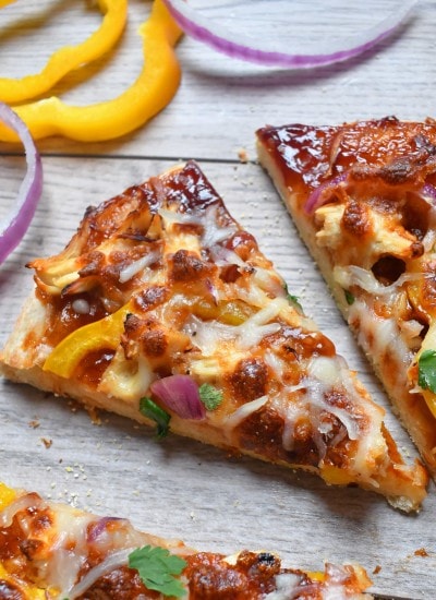 BBQ sauce, sweet peppers, red onions, chicken all a top homemade pizza crust for a BBQ chicken pizza that will have you coming back for more.