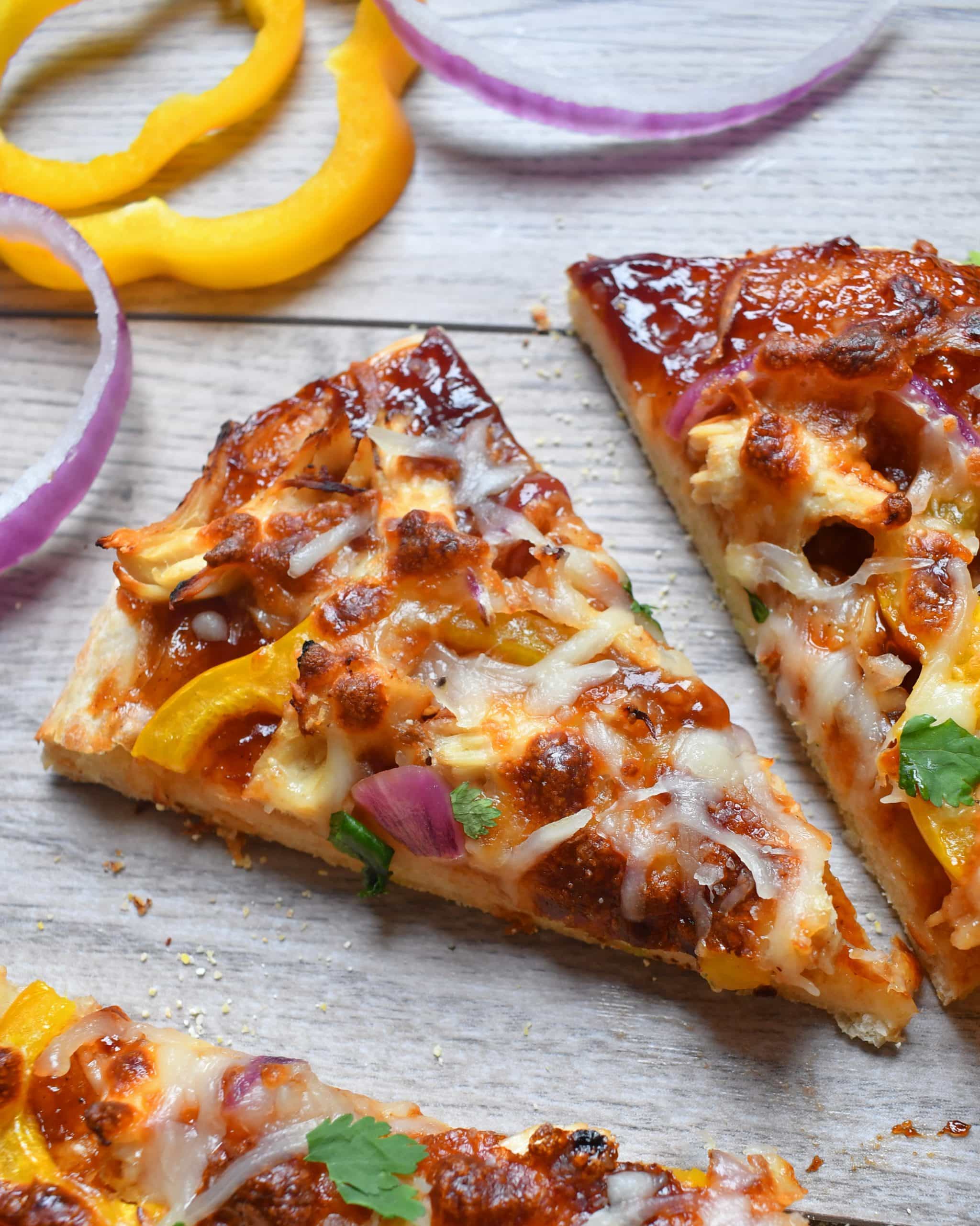 BBQ sauce, sweet peppers, red onions, chicken all a top homemade pizza crust for a BBQ chicken pizza that will have you coming back for more.