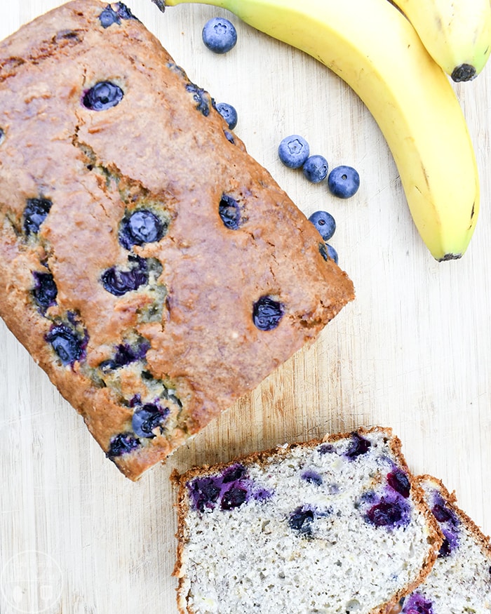 An overhead photo of banana blueberry bread with a couple slices off the front. 