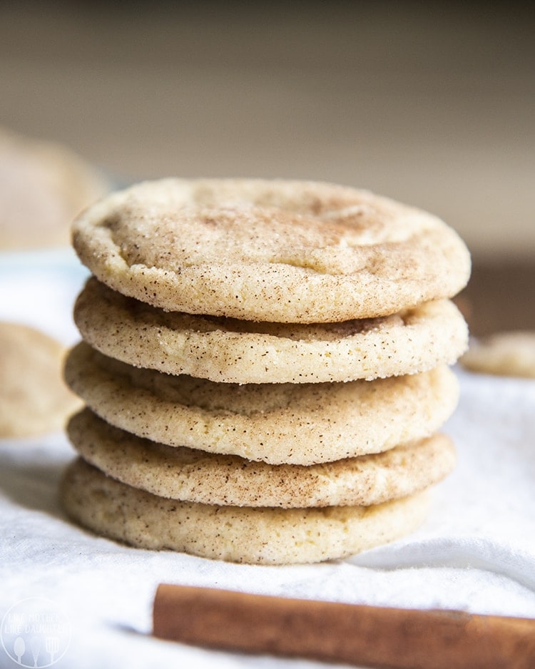 A stack of 5 snickerdoodle cookies coated in cinnamon sugar.