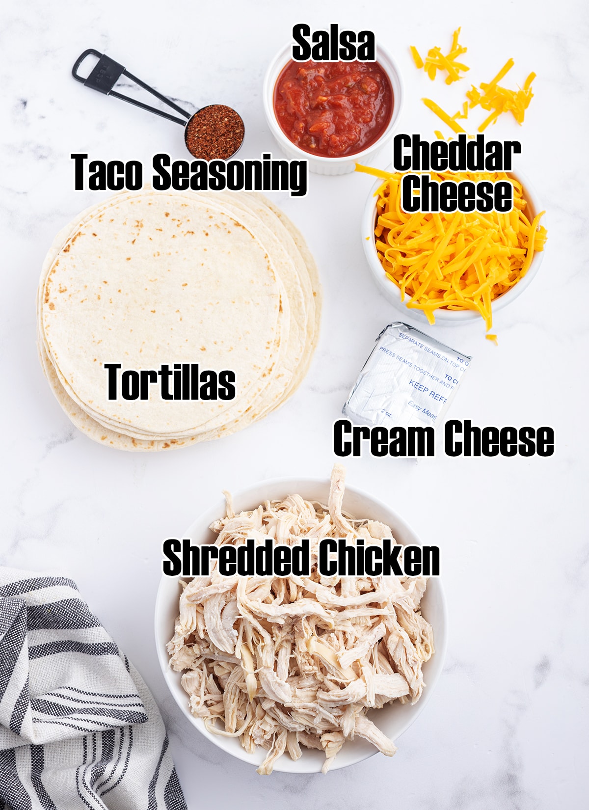 An overhead of the ingredients needed to make creamy chicken taquitos.