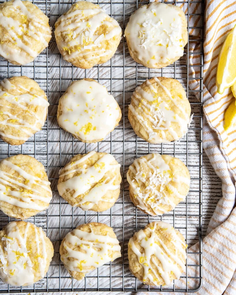 An above photo of thick cookies on a cooling rack topped with a white glaze and lemon zest.