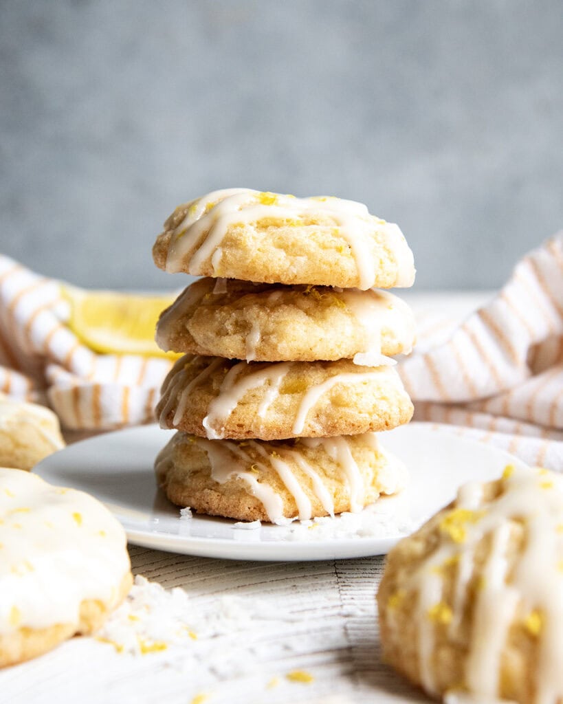 A stack of 4 cookies on a white plate.